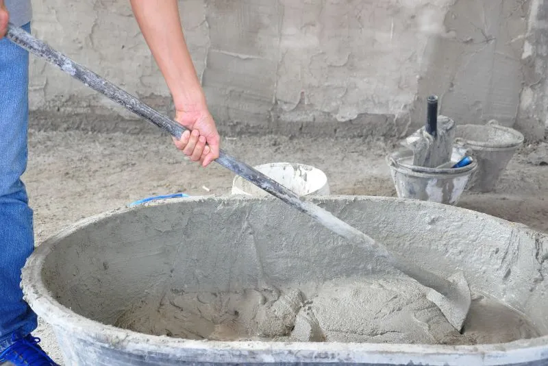 concrete worker mixing concrete