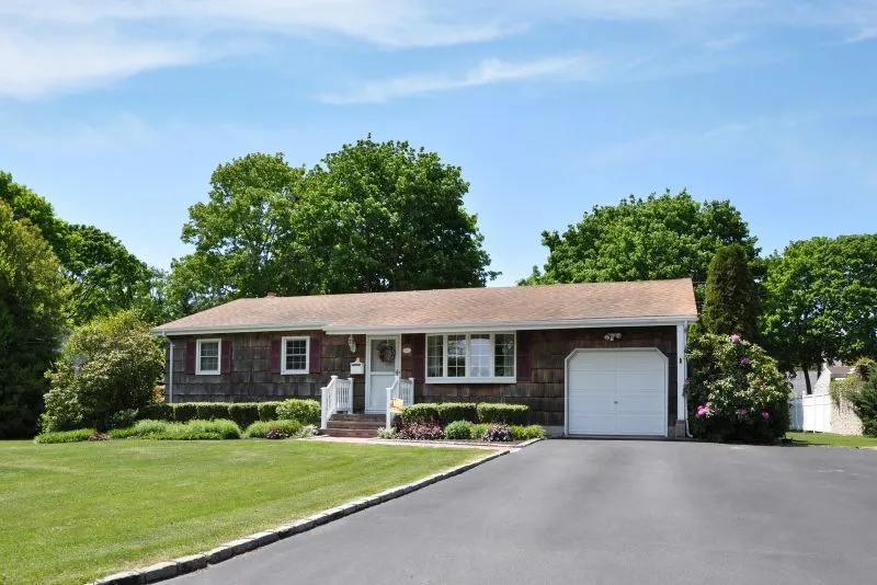 Concrete driveway leading up to a single-car garage door