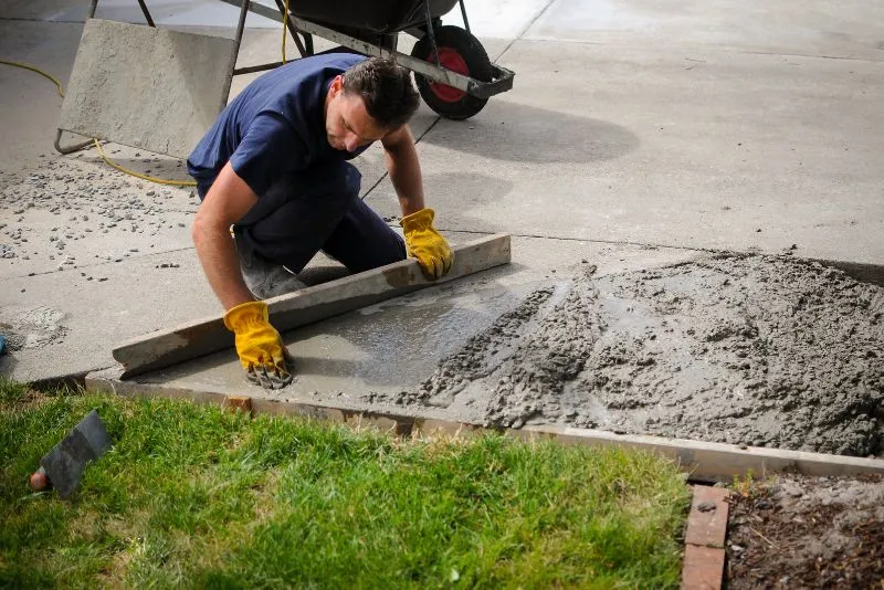 Concrete specialist resurfacing an existing driveway surface