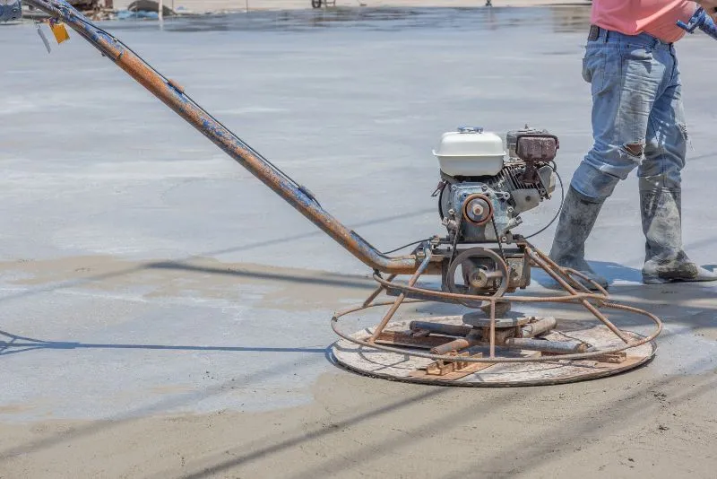 Concrete polishing and levelling machine smoothing a concrete floor surface