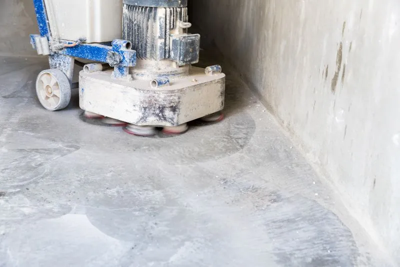 Concrete polishing machine grinding a floor to a smooth, glossy finish